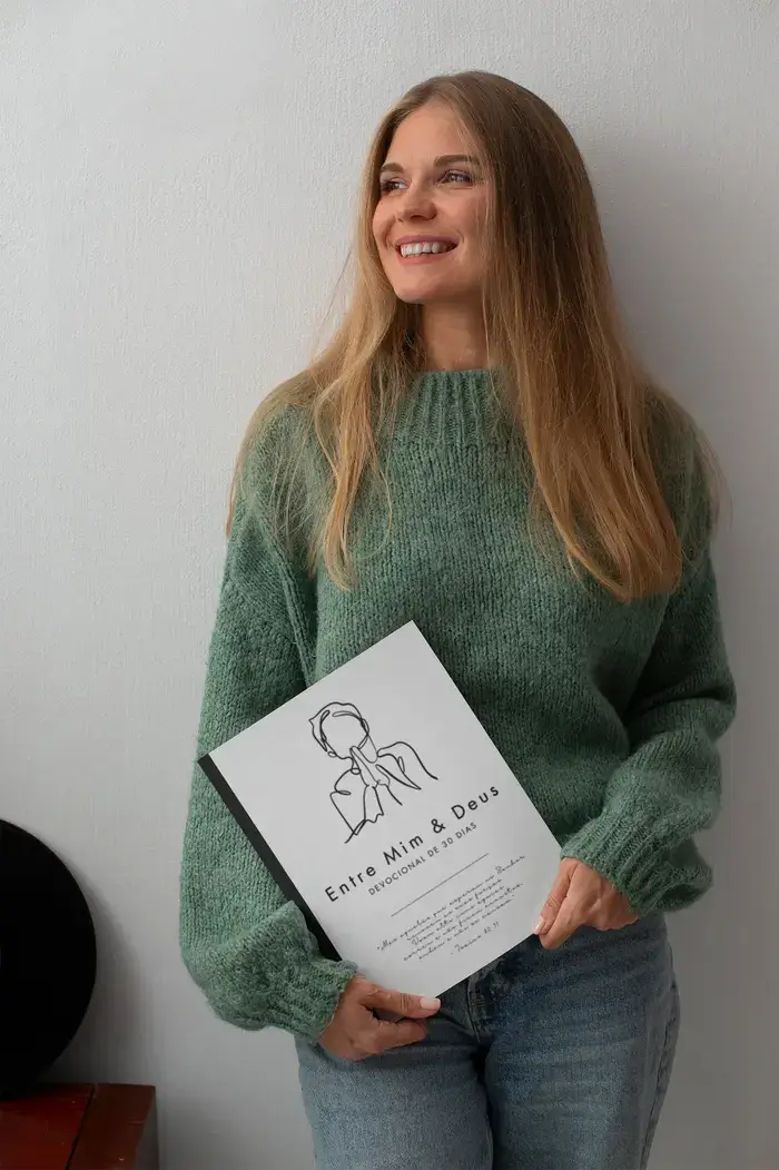 Mulher sorridente segurando o devocional Entre Mim e Deus